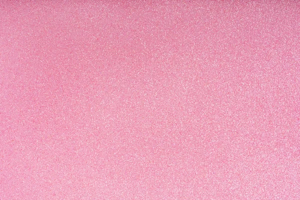 Holiday glowing pink sparkle backdrop. Abstract vibrant festive defocused light. Festive glitter christmas background. Glittering surface with glow effect. Blurred, bokeh, defocused. Party decoration.
