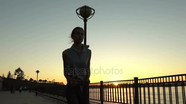 Jeune femme jogging au coucher du soleil — Video