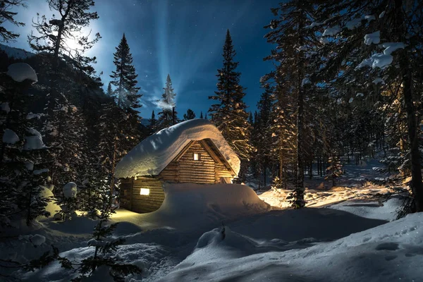 Pequeña casa de campo en un hermoso bosque de nieve en la noche de luna — Foto de Stock