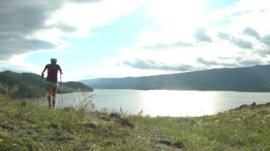 Yuvarlak dağ ve göl yürüme sırt çantası olan kadın