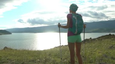 Yuvarlak dağ ve göl yürüme sırt çantası olan kadın
