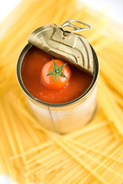 Tomato, open tomato can, pasta, spaghetti, Vegan diet food, creative cherry tomato composition isolated on white. Fresh basil, tomatoes, cooking concept, top view.