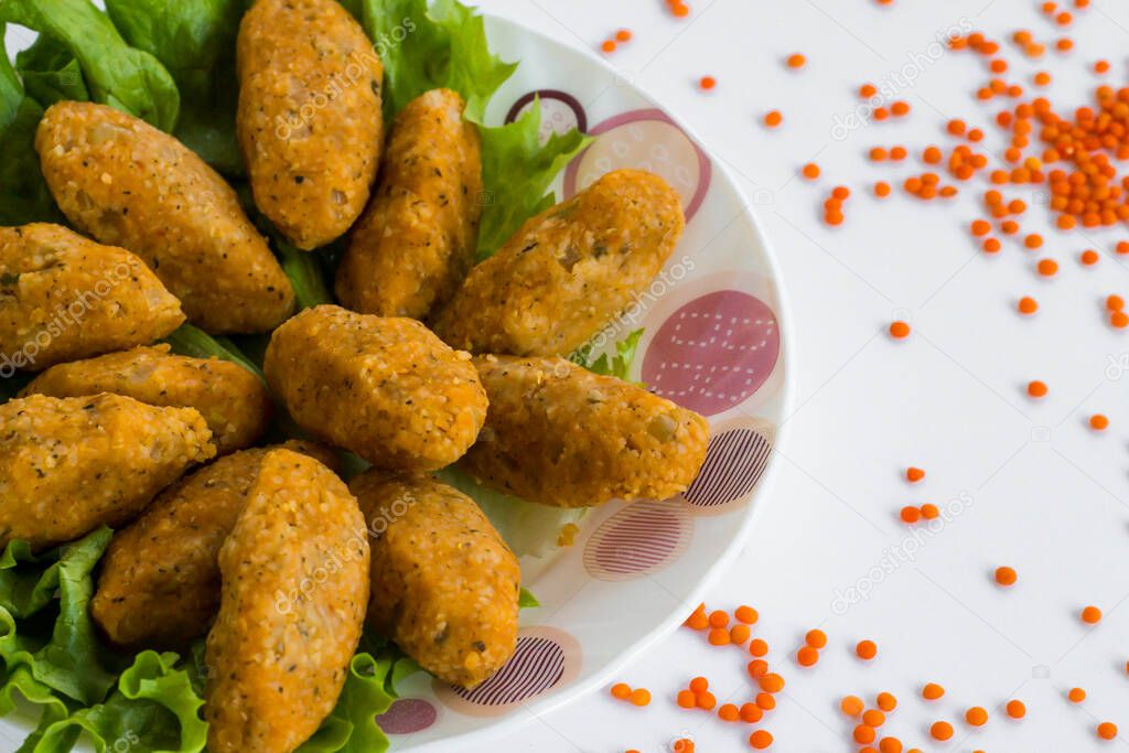Traditional Turkish lentil and bulgur patties on white with copy space.