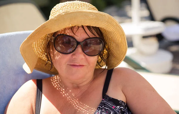 Senior woman wearing hat and sunglasses at beach — Stock Photo, Image