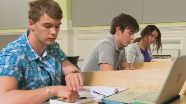 Estudiantes lanzando aviones de papel al estudiante — Vídeos de Stock
