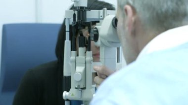 Bayan hasta erkek gözlükçü tarafından incelenir