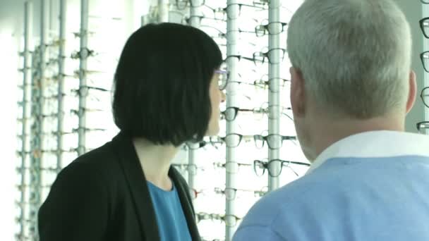 Optician offers the Female new glasses — Stock Video