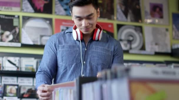 Young Man Browses of vintage records — Stock Video