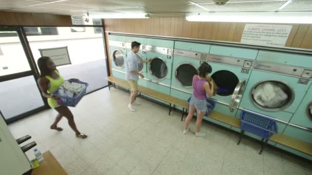 Three Young Adults doing their laundry — Stock Video