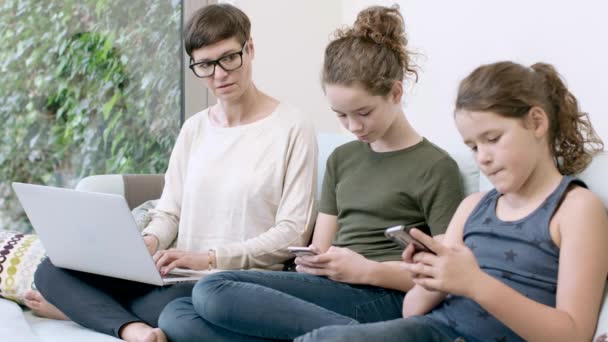 Мама з дочками використовує пристрої — стокове відео