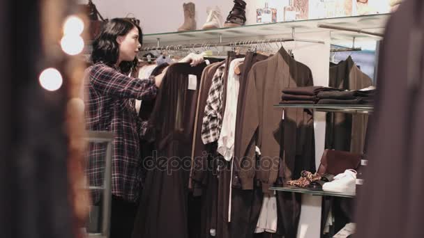 Young adult female looking at clothes — Stock Video