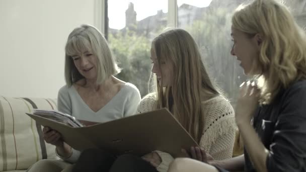 Three generation family sitting on sofa — Stock Video