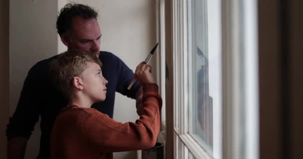 Son Helping Father Decorate — Stock Video