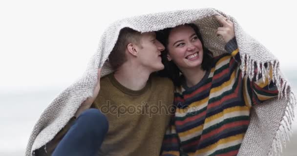 Young couple sheltering from rain Stock Footage