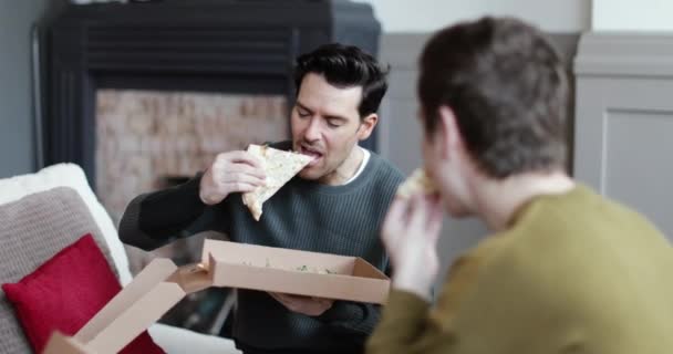 Young Male Couple Eating Pizza Home — Stock Video