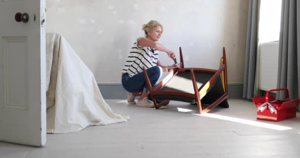 Mature Female Repairing Old Chair — Stock Video