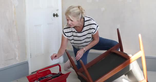 Mature Female Repairing Old Chair — Stock Video