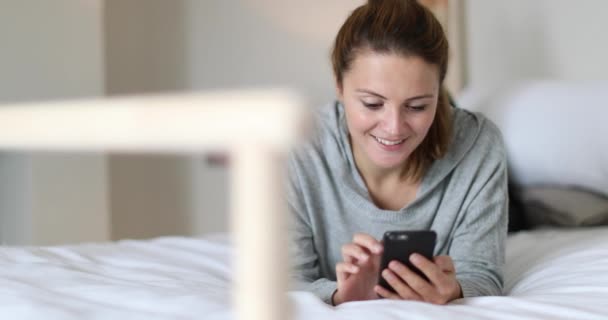 Young Adult Female Using Smartphone Bed — Stock Video