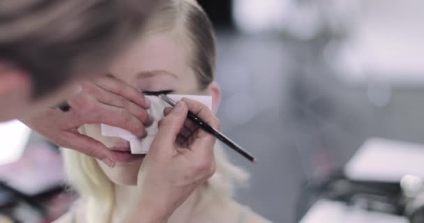 Make-up umělec dělá modelky oční linky na focení — Stock video