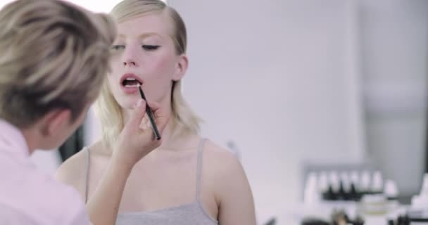 Makeup καλλιτέχνης βάζοντας κραγιόν σε ένα μοντέλο — Αρχείο Βίντεο