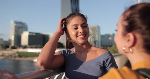 Hispanic Girlfriends hanging out on bridge at sunset — Stock Video