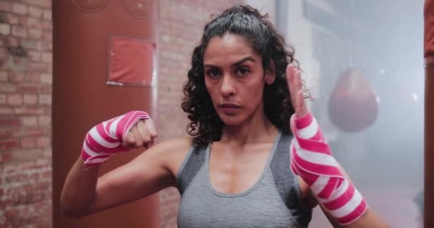 Portrait of female boxer with hand wraps — Stock Video