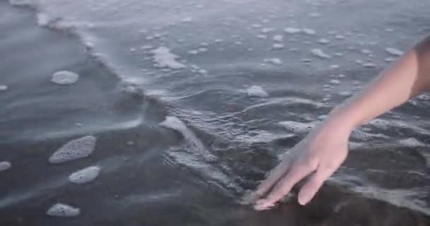 Zbliżenie kobieta ręka bawiąc się z woda w morze — Wideo stockowe
