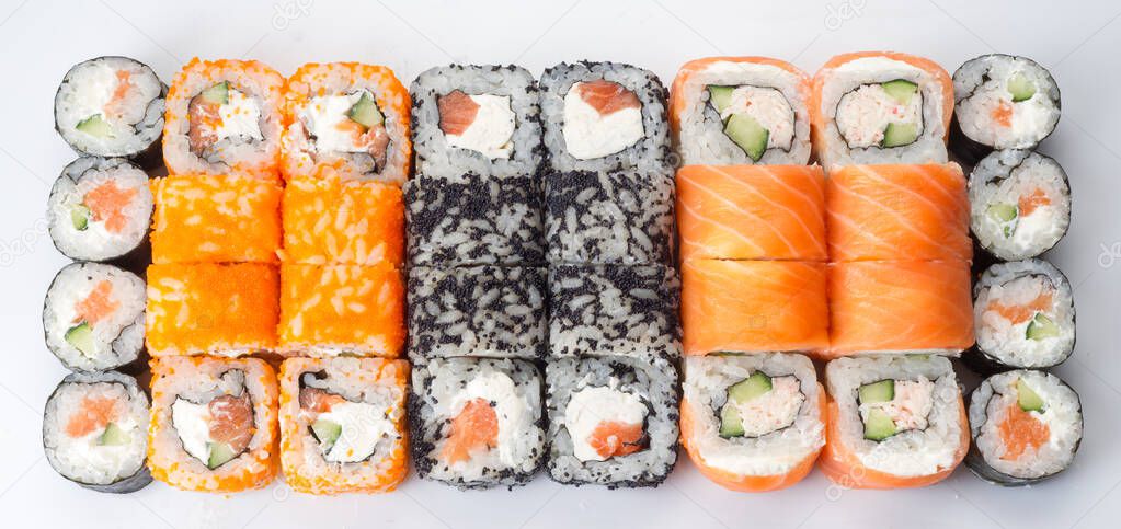 Big sushi rolls set isolated on white background. Tasty fresh sushi rolls. Japanese cuisine, asian food. Seafood, fish, rice