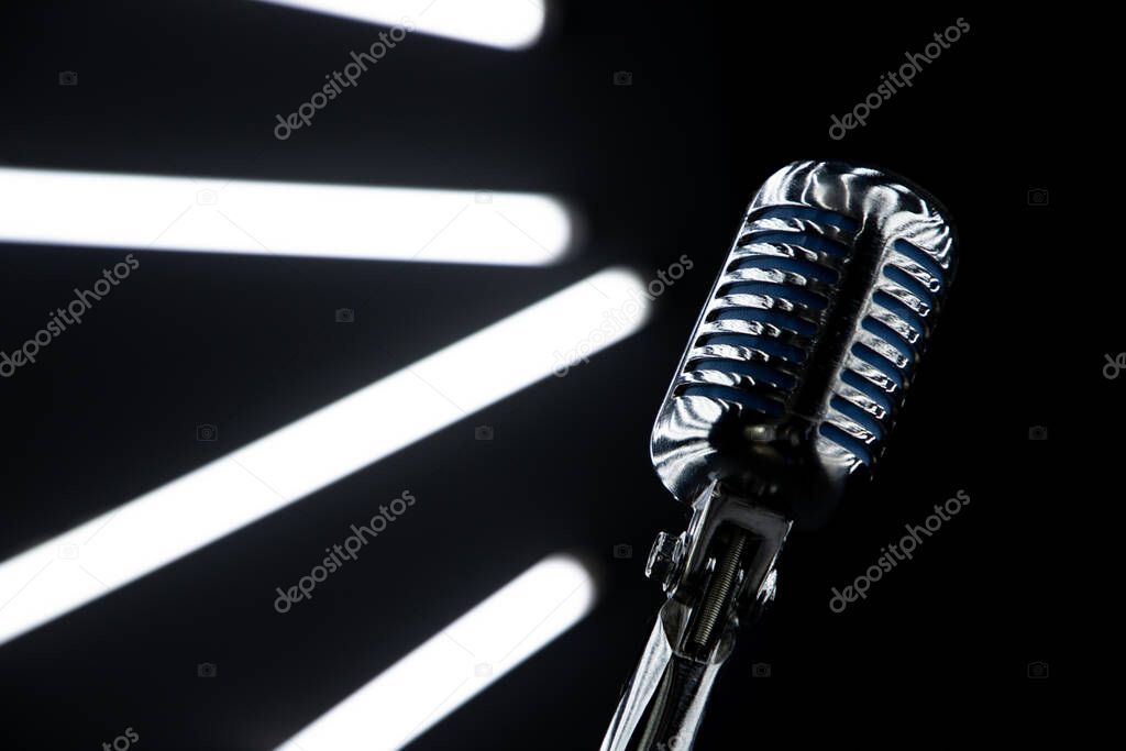 lose up of microphone in Music Studio with Black walls and lights at background