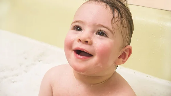 Little baby girl smiles in the bathroom — Stock Photo, Image
