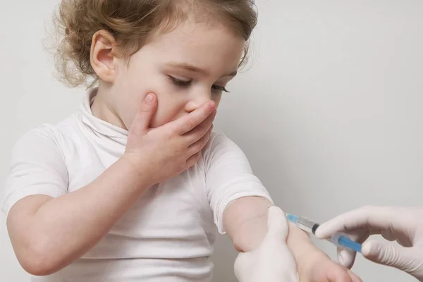 Doctor hand with syringe vaccinating baby girl flu injection shot vaccination — Stock Photo, Image