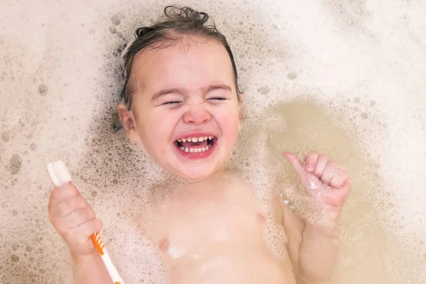 Happy little baby girl face swimming in the bathroom. — Stock Photo, Image