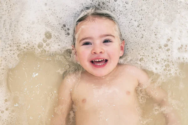 Adorable bath baby girl with soap suds on hair — Stock Photo, Image
