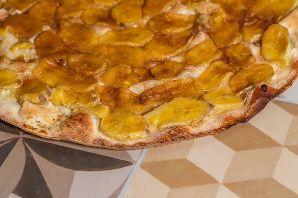 Sweet pizza with banana and cinnamon. Traditional Brazilian sweet pizza with banana