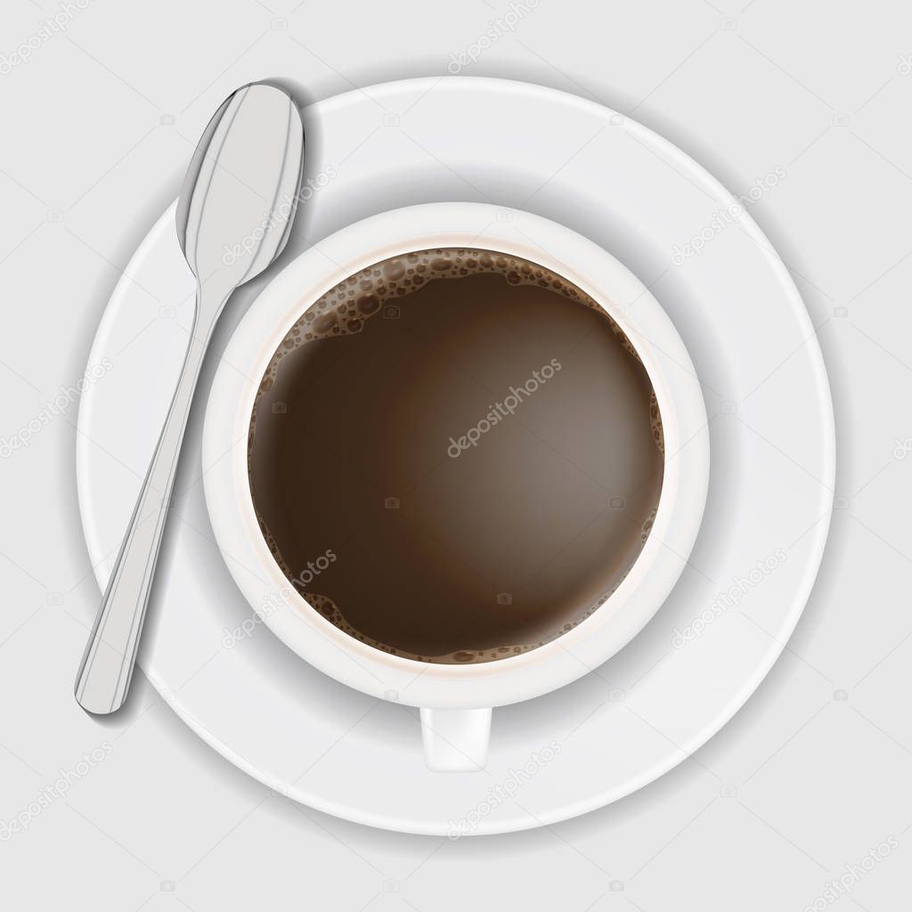 top view of coffee cup on dish with spoon