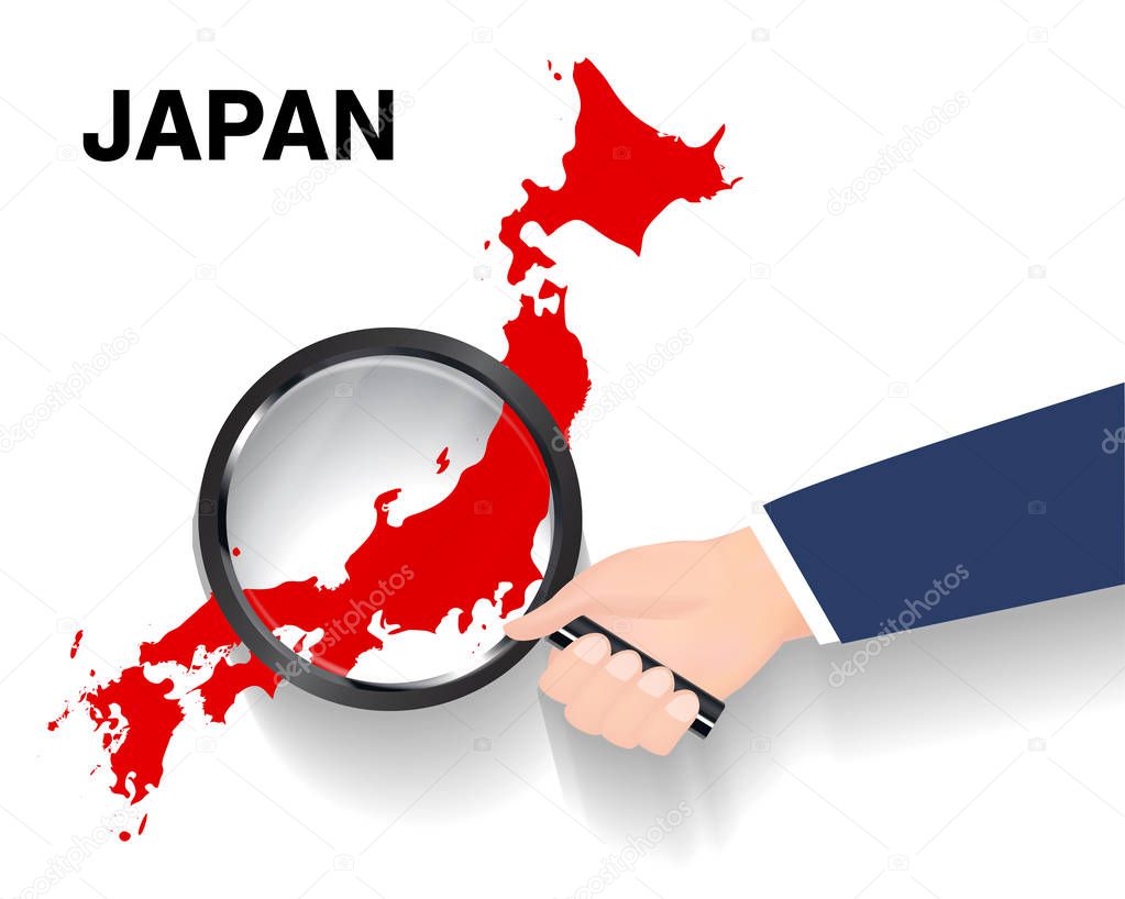 hand use magnifying glass searching on  japan map