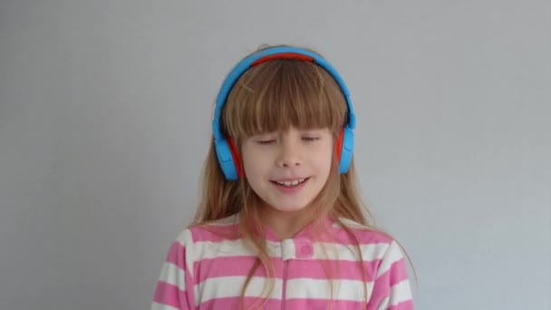 Cute Little Girl Listens Music Wireless Headphones — Stock Video
