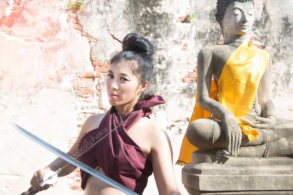 Pretty Asian woman posing in Thai ancient warriors.