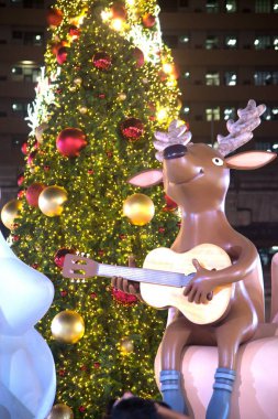 Ren geyiği heykel ışığında renkli süslemeleri güzel Noel ağacı kutlama Bangkok, Tayland.