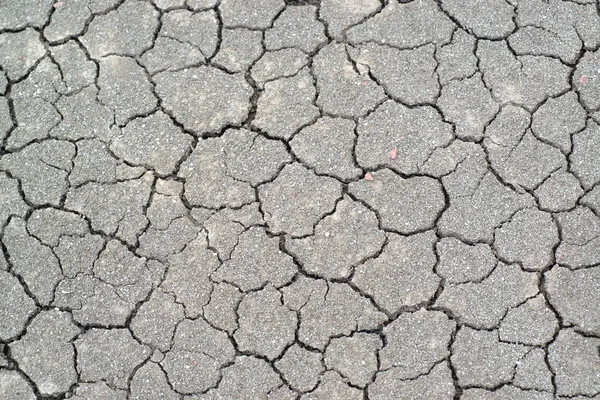 Above view of land during drought. Abstract surface in cracked ground, dry soil. Ecology concept. Cracked earth texture and background. — Stock Photo, Image