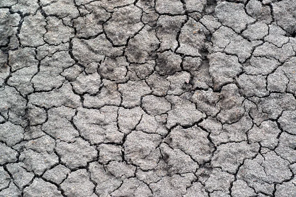Above view of land during drought. Abstract surface in cracked ground, dry soil. Ecology concept. Cracked earth texture and background. — Stock Photo, Image