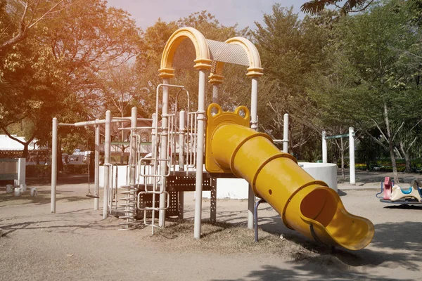 Playground equipment for kids playground on yard for any playground activities at public park with tree background. — Stock Photo, Image