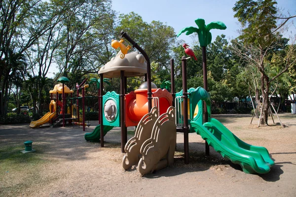 Playground equipment for kids playground on yard for any playground activities at public park with tree background. Stock Picture