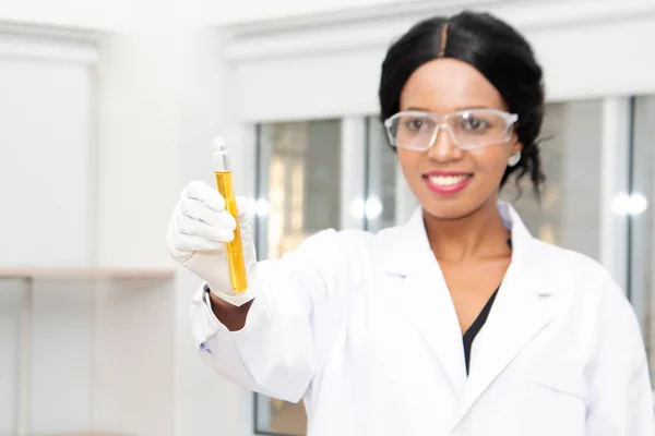 Forskare med utrustning och vetenskapliga experiment, laboratorieglas som innehåller kemisk vätska för forskning eller analys av ett prov i provrör i laboratorium. — Stockfoto