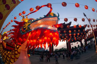 Red lanterns hanging in the blue sky and Dragon head lamp at twilight at the Lantern Festival in Chinese New Year Celebration.