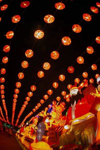 Red lanterns hanging in the black sky and god lamp at night in the Lantern Festival in Thailand.