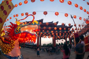 Red lanterns hanging in the blue sky and Dragon head lamp at twilight at the Lantern Festival in Chinese New Year Celebration.