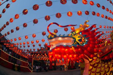 Red lanterns hanging in the blue sky and Dragon head lamp at twilight at the Lantern Festival in Chinese New Year Celebration.