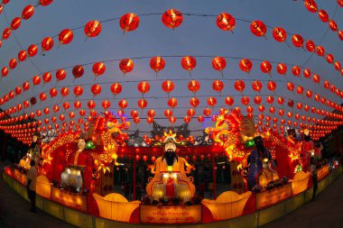 Original red lanterns in the blue sky and Godness lamp at twilight at the Chinese New Year Celebration. Year Lantern Festival.