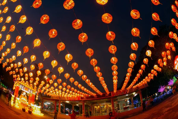 Red lanterns in the black sky and god lamp at night in the Chinese New Year Celebration in Thailand. — Stockfoto